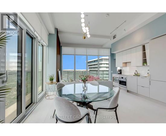 A modern dining room with a glass table and chairs.