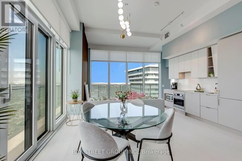 A modern dining room with a glass table and chairs.