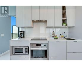 A modern kitchen with a microwave and oven built into the counter.