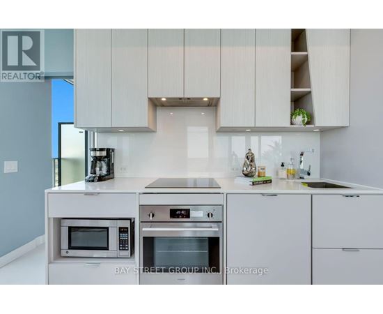 A modern kitchen with a microwave and oven built into the counter.