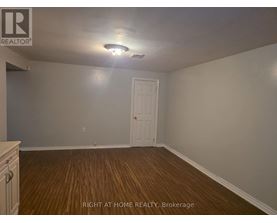 A room with a door and a light on the ceiling.