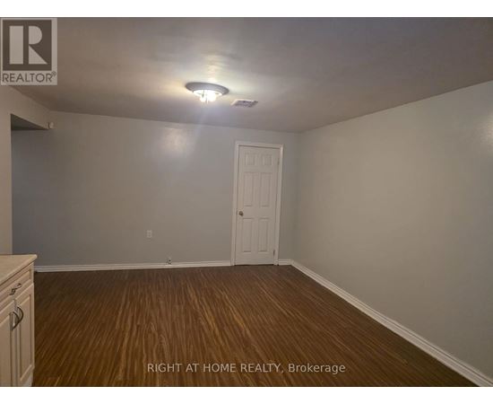 A room with a door and a light on the ceiling.