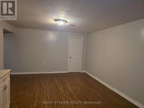 A room with a door and a light on the ceiling.