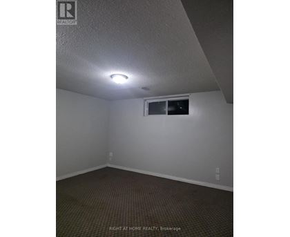 A room with a window and a light on the ceiling.