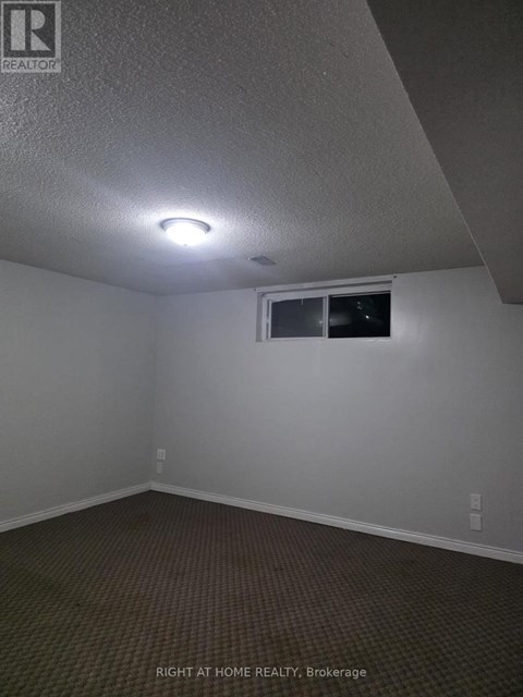 A room with a window and a light on the ceiling.