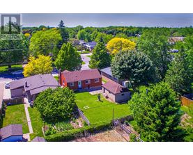 A bird's eye view of a residential area with houses and trees.