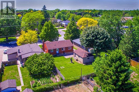 A bird's eye view of a residential area with houses and trees.