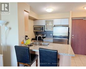 A kitchen with a sink, microwave, and oven.