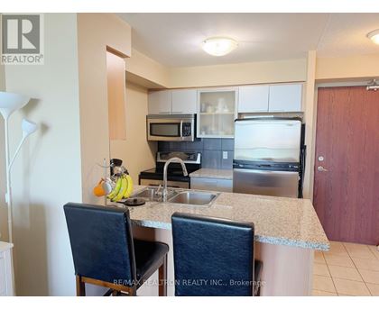A kitchen with a sink, microwave, and oven.