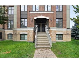 A building with a brick facade and a set of stairs leading to the entrance.