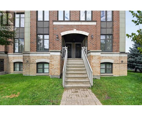A building with a brick facade and a set of stairs leading to the entrance.