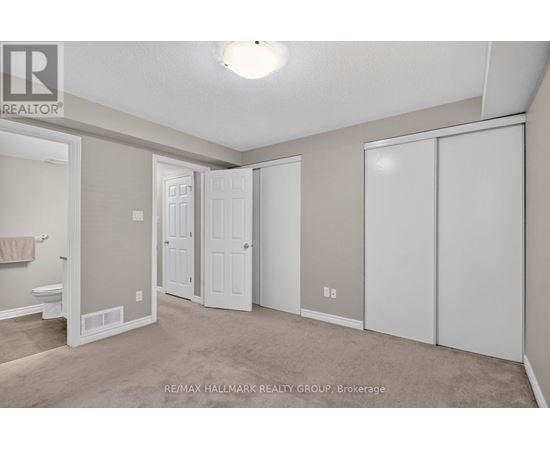 A bedroom with a toilet and a bathtub in it.