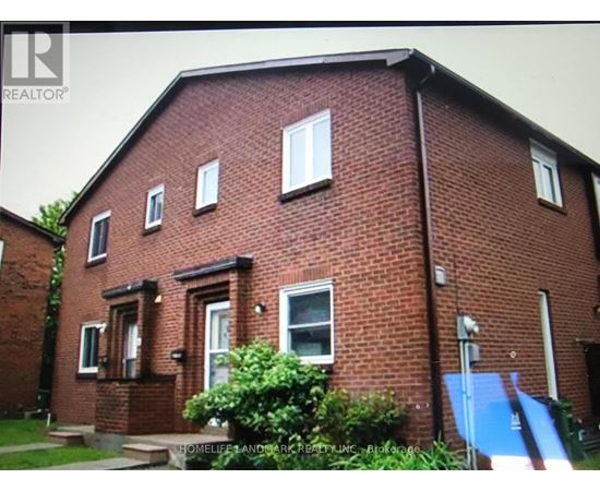 A red brick house with a blue tarp on the right side.