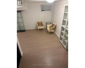 A room with a chair and a table in it.