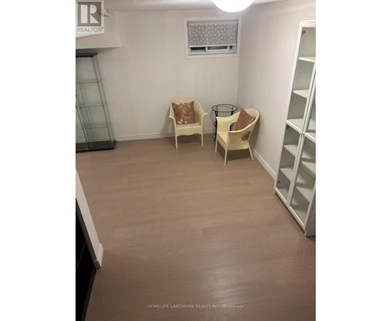 A room with a chair and a table in it.