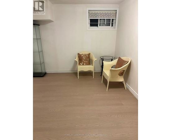 Two chairs and a table are in a room.