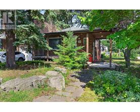 A house with a sign that says "REALTOR" in the front yard.