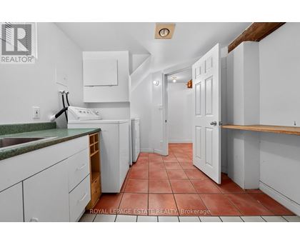 A kitchen with white cabinets and a green counter top.