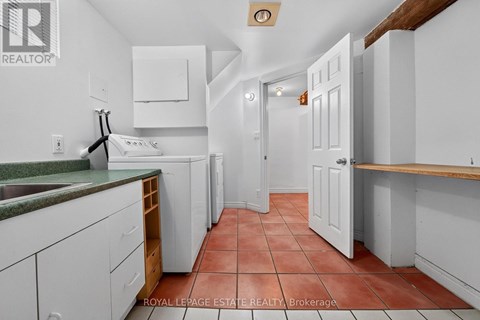 A kitchen with white cabinets and a green counter top.