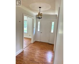 A room with wooden floors and white walls.