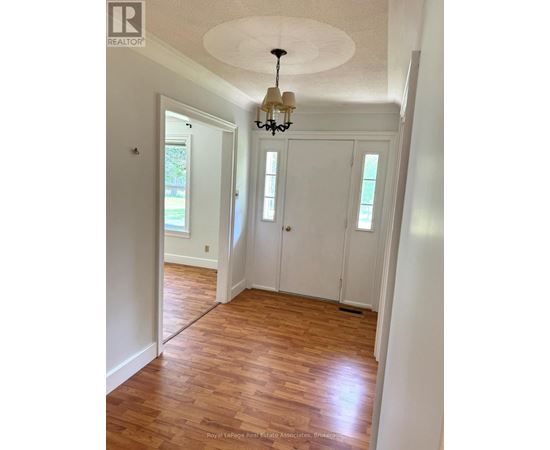 A room with wooden floors and white walls.