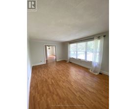 A room with wooden floors and white walls.