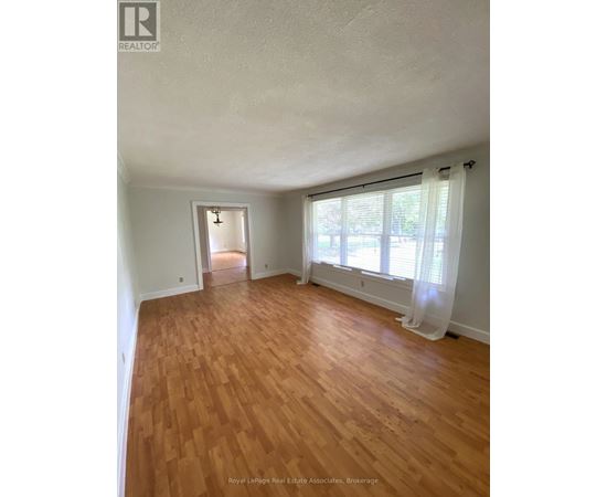 A room with wooden floors and white walls.