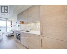 A modern kitchen with wooden cabinets and a stainless steel stove.
