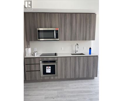 A modern kitchen with a microwave above the stove.