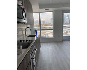 A modern kitchen with a view of the city skyline.