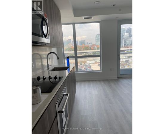 A modern kitchen with a view of the city skyline.