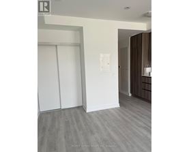A room with a sliding door and a light switch on the wall.