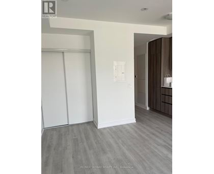 A room with a sliding door and a light switch on the wall.