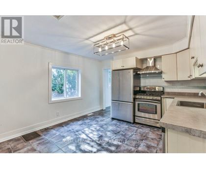 A kitchen with a stainless steel refrigerator, oven, and microwave.