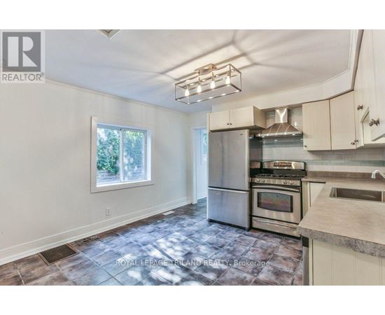 A kitchen with a stainless steel refrigerator, oven, and microwave.