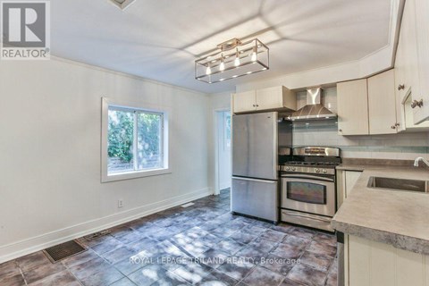 A kitchen with a stainless steel refrigerator, oven, and microwave.