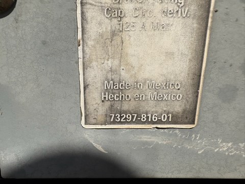 A metal plate with text in English and Spanish that says "Made in Mexico" and a phone number.