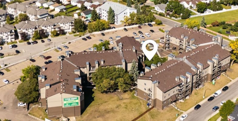 A bird's eye view of a parking lot with a building and a sign that says "Last Stop".