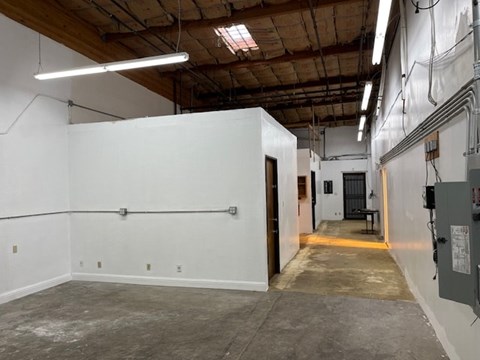 A large empty room with a door on the right side.