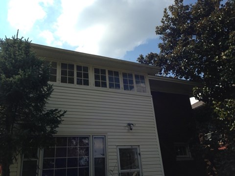 A house with a white siding and a window on the side.
