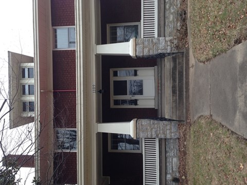 A building with a red brick facade and white trim.