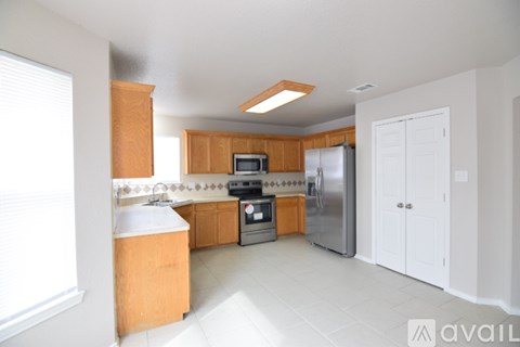 A kitchen with wooden cabinets and stainless steel appliances.