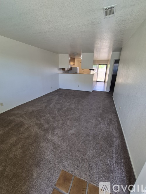 A room with a carpeted floor and white walls.