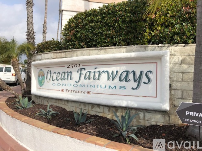 Ocean Fairways Condominiums sign with a white van in the background.