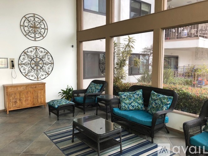A living room with a sofa, chairs, and a coffee table.