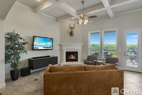 A living room with a fireplace, a television, and a couch.