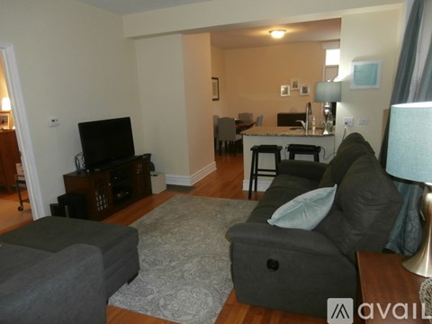 A living room with a grey couch and a television.