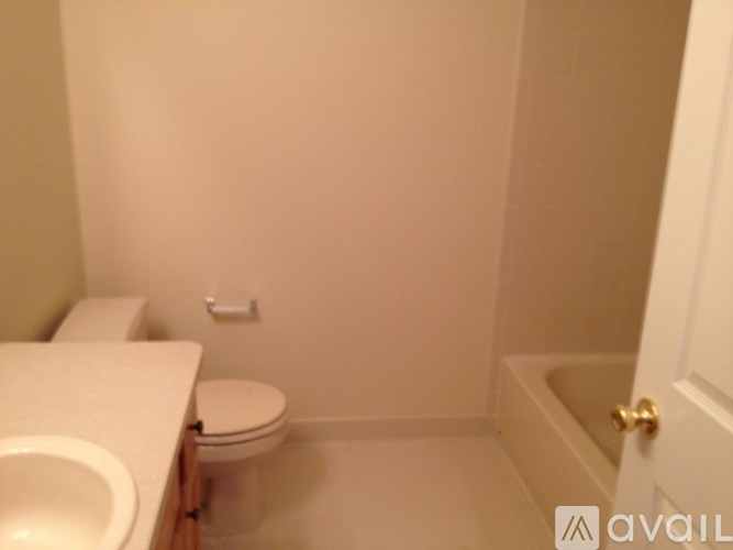 A bathroom with a toilet, sink, and bathtub.