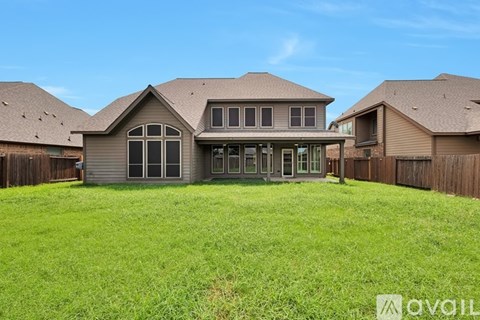 A large house with a big lawn in front.