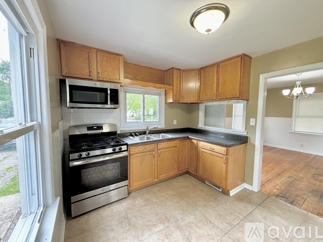 A kitchen with wooden cabinets and a black stove top oven.